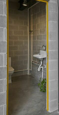 an open door leading to a bathroom with a sink and toilet