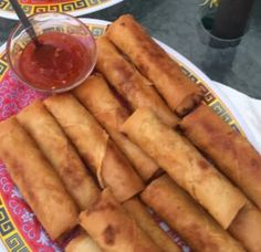 some food is sitting on a plate with dipping sauce