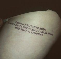 a person with a tattoo on their back saying from my rotting body powers shall grow and i am in them and that is eternity