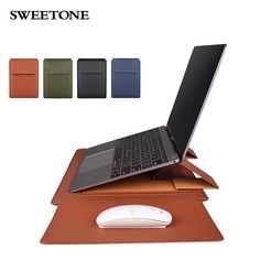 an open laptop computer sitting on top of a brown leather pad with four different colors