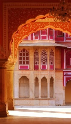 an ornate building with red and white walls