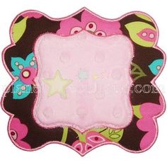 a pink and brown flowered placemat with a star on the center in the middle