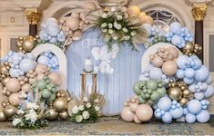 balloons and flowers are arranged in the shape of an arch