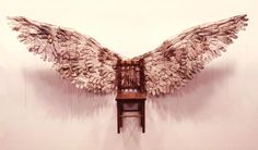 an artistic photo of a chair with wings on it