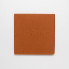 an orange book with the words private tuscany on it