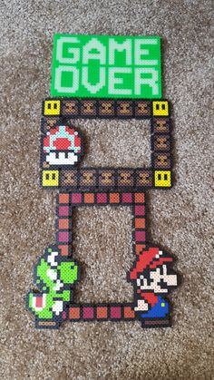 an image of a game over sign made out of perler beads on the floor