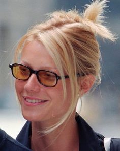 a blonde woman with glasses and a ponytail