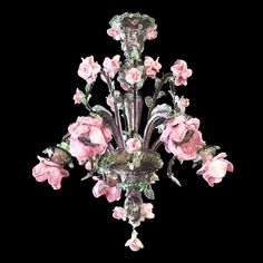 a chandelier with pink flowers hanging from it's sides and green leaves