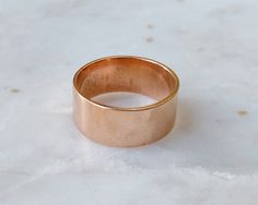 A beautiful solid pure copper ring.  DETAILS: ♡ This ring is made of pure copper and is approximately 7.7 mm thick   ♡ Comes with a polishing cloth ♡ Simply select the size at checkout ♡ Comes packaged beautifully with copper care instructions. The copper used has been left in its natural state and may develop a patina over time, darkening its original colour, this will only add beauty to each piece! You can brighten it with diluted lemon juice or vinegar, rinse and dry after.  PROCESSING: ♡ We work on orders in the order received. Standard turn-around typically takes up to 1 - 2 business days. (This does not include shipping time). SHIPPING INFO: ♡ Items are shipped in 2-3 business days (excludes weekends and holidays) ♡  All domestic orders are shipped via untracked/uninsured Canada wide Rose Gold Wide Band Ring As Gift, Vinegar Rinse, Copper Uses, Copper Ring, Copper Rings, Pure Copper, Moscow Mule Mugs, Lemon Juice, Band Rings