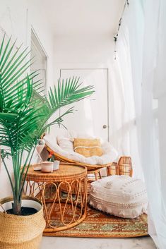 a living room with wicker furniture and plants