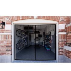 an open garage door with bicycles on the rack