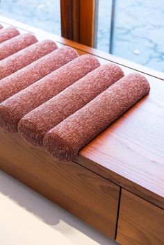 a close up of a wooden bench with a towel on it