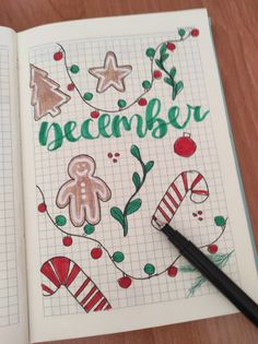 an open notebook with the word december written in green and decorated gingerbreads on it