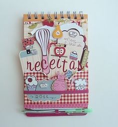 a spiral notebook with magnets on top of it and an image of a hot air balloon