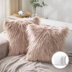 two furry pillows on a couch in front of a window