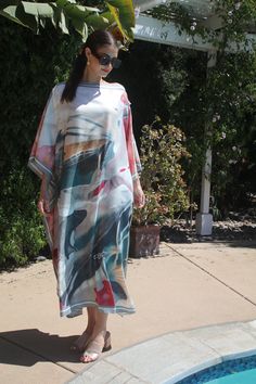 Enjoy this beautiful, abstract print caftan with the look of a hand painting.  Soft, muted colors blend in together with the look of an artist's brush subtlly expressing itself upon a canvas.  A beautiful combination of blues, grays, mauves and peach on a creamy background, offer a feeling of elegance and calm.   One size.  Fits small to X-large sizes.  The width is 51 inches, edge to edge, the side seams are 6 inches from the edge, giving 78 inches for body room and a flowing, elegant look.  th Spring Bohemian Kaftan With Abstract Print, Multicolor Abstract Print Kaftan For Spring, Beach Dress With Kimono Sleeves And Abstract Print, Spring Multicolor Kaftan With Abstract Print, Spring Multicolor Abstract Print Kaftan, Multicolor Abstract Print Kaftan For The Beach, Multicolor Abstract Print Kaftan For Beach, Summer Multicolor Abstract Print Kaftan, Artistic Multicolor Beach Dress