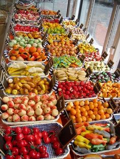 many baskets filled with different types of fruits and vegetables