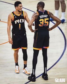 two basketball players standing next to each other on a court