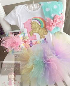 Unicorn birthday shirt or bodysuit in pastel rainbow. The glittery gold unicorn is stunning! This top can be made with any birthday number. The number is sewn with a pink polka dot fabric and unicorn with a shimmery gold fabric. The rainbow is sewn in pastel shades of pink, orange, yellow, green, blue and lavender, Her name will be added in pastel colors in a pretty cursive font. Matching bottoms and bows available in the shop! Unicorn Birthday Shirt, Unicorn Birthday Outfit, Unicorn Themed Birthday Party, Magical Birthday, Unicorn Outfit, Ruffle Leggings, Birthday Tutu Outfit, Unicorn Shirt, Cake Smash Outfit