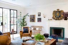 a living room filled with furniture and a fire place in front of a glass door