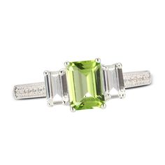 This sophisticated ring centers a vivid emerald-cut peridot flanked on either side by an emerald-cut white lab-created sapphire. Round white lab-created sapphires sparkle down the gleaming sterling silver band to complete the elegant look. White Lab, Peridot Stone, Elegant Look, Silver Prices, Emerald Stone, Sapphire Stone, Three Stone Rings, Sterling Silver Bands, Ring Sterling Silver