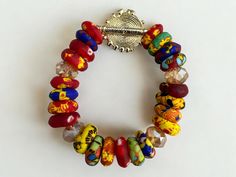 Add a touch of ethnicity to your jewellery collection with this beautiful multicolored Krobo beads bracelet from West Africa. The bracelet features elasticity, making it easy to slip on and off, and is perfect for any occasion. The brass charm type is a bead and the style is beaded, giving it a unique and eye-catching look. Perfect for those who love to explore different cultures. It is versatile and stylish. Beads Diameter: 1cm Material: Beads, Brass One bracelet  supplies Artisan Multicolor Beaded Bracelets For Festivals, Traditional Multicolor Stretch Bracelet As Gift, Artisan Multicolor Beaded Bracelets With Round Beads, Bohemian Stretch Bracelet With Spacer Beads, Traditional Multicolor Bracelets With Spacer Beads, Artisan Multicolor Stretch Bracelet With Round Beads, Artisan Multicolor Beaded Stretch Bracelet, Bohemian Stretch Bracelet With Large Beads, Unique Adjustable Multicolor Stretch Bracelet