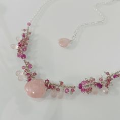 This perfect bridesmaid or maid of honor necklace consists of a lovely focal morganite gemstone (15 mm across) and smaller rose quartz teardrop briolettes (8 mm long) alongside pink sapphire (4 mm), tiny pink tourmaline (2 mm) and mystic pink topaz (4 mm) rondelles. These gemstones are fine quality with excellent faceting or polish. The entire necklace measures approximately 16 to 20-inches long with the 4-inch extender. This piece is completed in slightly oxidized and bright sterling silver. Ha Pink Gemstone Necklace, Morganite Gemstone, Quartz Pink, Pink Topaz, Small Rose, Pink Gemstones, Pink Quartz, Morganite, Pink Tourmaline