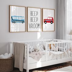 a baby's room with two posters on the wall