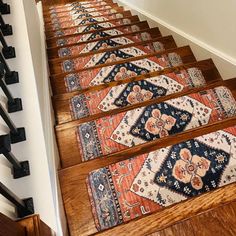 a set of stairs with rugs on them