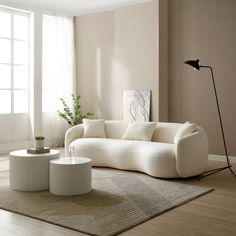 a living room filled with furniture next to a window and a rug on top of a hard wood floor