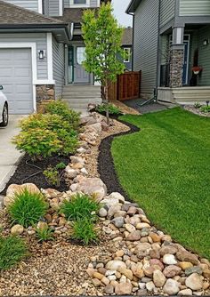 a car parked in front of a house next to a rock and gravel garden bed