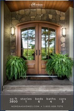 the front door to a home with two plants on it and an advertise