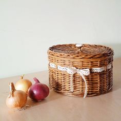 an onion basket next to some onions on a table