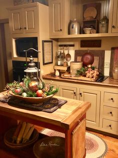 a kitchen filled with lots of wooden cabinets and counter top covered in christmas decorations next to an oven