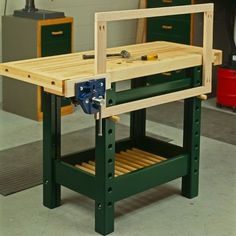 a workbench in a garage with tools on the table and drawers below it