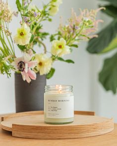 a candle sitting on top of a wooden tray