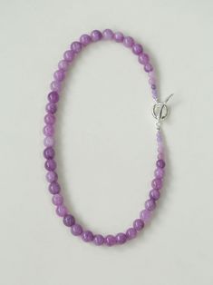 Embrace the essence of spring and summer with our Lavender Grapevine Gemstone Beaded Necklace! The enchanting purple hue exudes a blend of dreaminess and a hint of mystery. Crafted with romantic healing lavender gemstones delicately strung together, complemented by a minimalist OT clasp, this necklace embodies gentle elegance with a touch of individuality. Perfectly versatile, it effortlessly elevates any ensemble, whether paired with a solid-colored tee or a breezy resort sundress, exuding a charming Southern French allure. Metal: Recycled Sterling Silver Plated On Brass Gemstone: Natural Stone 10mm Length: 480mm Weight: 60g Edison Pearls, Gemstone Beaded Necklace, Tiger Eye Stone, Purple Hues, Recycled Sterling Silver, Stone Necklace, Ring Bracelet, Grape Vines, Stone Rings