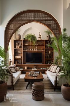 a living room filled with lots of furniture and plants