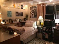 a bed room with a neatly made bed and lots of lights on the wall above it