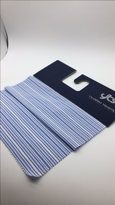 a blue and white striped cloth with a credit card attached to the front of it