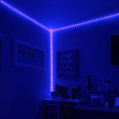 the room is lit up with blue lights and pictures on the wall, along with bookshelves