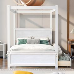 a white bed sitting on top of a wooden floor next to a wall mounted clock