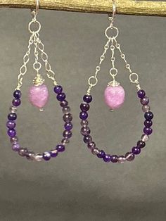 Artisan designed and handcrafted making these earrings are one of a kind. Purple and lavender amethyst wire wrapped beads. These earrings are dangling down the sterling silver chain. These purple amethyst are making a bead hoop. Lavender amethyst large beads are wire wrapped and dangling on a sterling silver chain attached to the lever back earring wire. This pair of earrings are a great presentation of a hoop earring. These earrings are a perfect gift. Total measurement 3 inches long including Handmade Purple Chandelier Earrings As Gift, Teardrop Amethyst Chandelier Earrings For Jewelry Making, Purple Teardrop Chandelier Earrings As Gift, Gift Purple Jewelry With Dangling Beads, Purple Wire Wrapped Dangle Jewelry, Purple Wire Wrapped Long Drop Jewelry, Purple Jewelry With Dangling Beads For Gift, Purple Chandelier Earrings With Ear Wire As A Gift, Purple Wire Wrapped Chandelier Earrings As A Gift