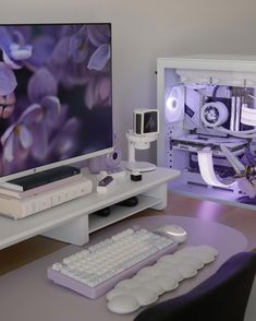 a computer monitor sitting on top of a white desk next to a keyboard and mouse