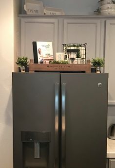 a refrigerator with the door open and water dispenser on top