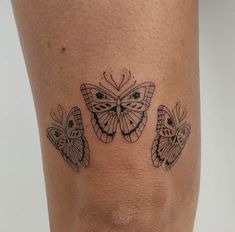 a woman's leg with three butterflies on it