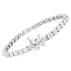 This authentic Tiffany diamond bracelet is substantial and absolutely fantastic quality! A diamond tennis bracelet is a time tested look that will always be in style! Highlights: - 4.49 carats of diamonds for fantastic, substantial sparkle! - The diamonds are very high quality, bright white and exceptionally clean, graded F-G VS - Excellent cut round brilliants for fantastic brilliance and sparkle - Marquise diamonds on the clasp add an elegant touch - Sturdy and solid construction in platinum - Authentic Tiffany & Co - Overall very high quality! Dimensions: 7 inches in length. Tiffany Tennis Bracelet, Tennis Bracelet Diamond Tiffany, Tiffany Victoria, Tiffany And Co Bracelet, Tiffany And Co Jewelry, Tiffany Diamond, Tiffany Bracelets, Bracelet Tennis, Antique Bracelets