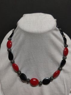 "Proudly display your love and support of your favorite red and black team.  This one of kind necklace includes red and black beads with easy close toggle clasp.  The necklace is 21\" in length.  This beautiful original will be a fine addition to your team spirit collection!" Adjustable Red Necklaces With Oval Beads, Adjustable Red Necklace With Oval Beads, Adjustable Red And Black Beaded Necklace, Adjustable Red Necklace With Black Beads, Adjustable Red Beaded Necklace With Black Beads, Adjustable Red Jewelry With Black Beads, Handmade Black Necklaces With Oval Beads, Handmade Black Necklace With Oval Beads, Red Necklace With Black Beads For Gift