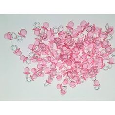 pink and silver colored beads on white background with clippings in the shape of circles