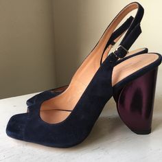 New And Unworn. Purchased At Sample Sale. Fits Like A Size 6. Shoe Is Navy Suede. Sculptural Half Circle / Heel Is Metallic Purple. 3.75” Heel Height. Note - Right Shoe Is 36.5 And Left Shoe Is 36. They Look The Same Size When I Compare Side By Side And They Feel The Same When I Wear Them. It’s Possible My Right Foot Is Slightly Bigger Than My Left. Purple Open Toe Heels With Sculpted Heel, Blue Slingback Pumps With Removable Insole For Evening, Blue Evening Slingback Pumps With Removable Insole, Purple Heels With Sculpted Open Heel, Modern Purple Heels For Evening, Modern Purple Open Toe Heels, Purple High Heel Slingback Pumps For Formal Occasions, Chic Purple Slingback Pumps For Spring, Chic Purple Slingback Pumps For Formal Occasions